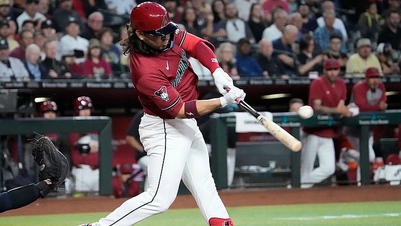 Arizona Diamondbacks third baseman Eugenio Suarez (28) hits a single against the New York Yankees during the first inning at Chase Field in Phoenix on April 2, 2024.