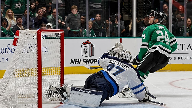 DALLAS, TX - DECEMBER 01: Winnipeg Jets goaltender Connor Hellebuyck (37) blocks a shot during the game between the Dallas Stars and the Winnipeg Jets on December 1, 2024 at American Airlines Center in Dallas, Texas. (Photo by Matthew Pearce/Icon Sportswire)