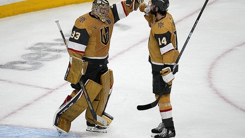 Vegas Golden Knights goaltender Adin Hill (33) and defenseman Nicolas Hague (14) celebrate after Game 2 of the NHL hockey Stanley Cup Finals against the Florida Panthers, Monday, June 5, 2023, in Las Vegas. The Golden Knights defeated the Panthers 7-2 to take a 2-0 series lead. (AP Photo/Abbie Parr)