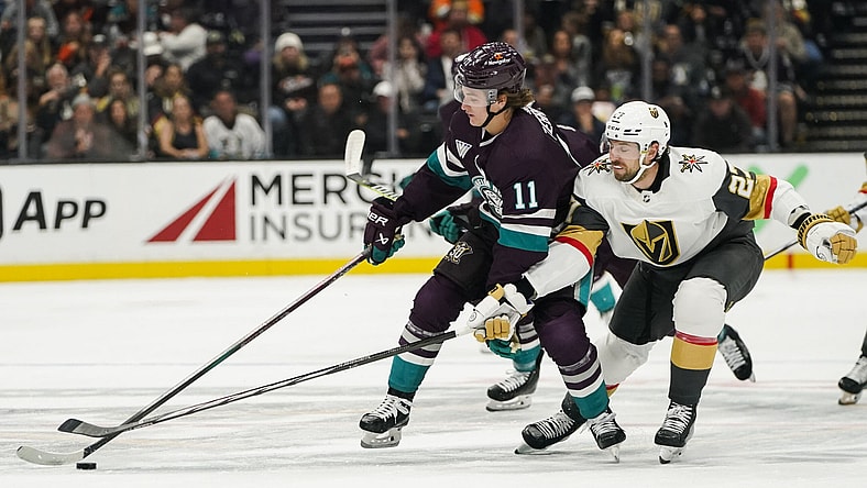 Anaheim Ducks center Trevor Zegras, left, and Vegas Golden Knights defenseman Shea Theodore vie for the puck during the first period of an NHL hockey game Sunday, Nov. 5, 2023, in Anaheim, Calif. (AP Photo/Ryan Sun)