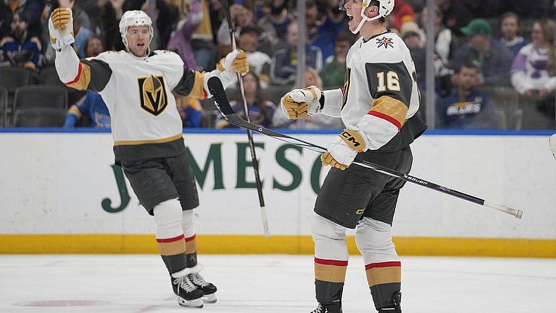 Vegas Golden Knights' Pavel Dorofeyev (16) celebrates after scoring as teammate Ben Hutton watches during the first period of an NHL hockey game against the St. Louis Blues Monday, March 25, 2024, in St. Louis. (AP Photo/Jeff Roberson)