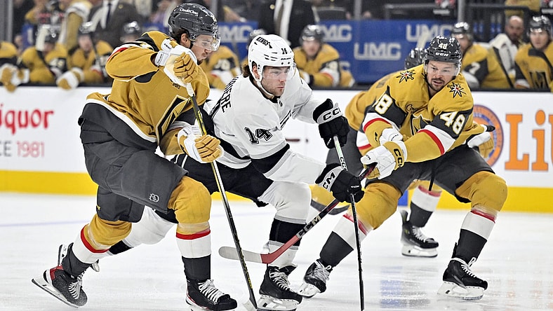Los Angeles Kings right wing Alex Laferriere (14) skates between Vegas Golden Knights center Brett Howden (21) and center Tomas Hertl (48) during the first period of an NHL hockey game Tuesday, Oct. 22, 2024, in Las Vegas. (AP Photo/David Becker)