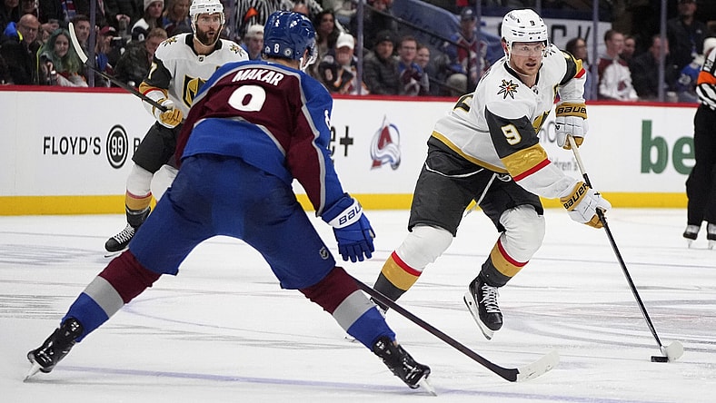 Vegas Golden Knights center Jack Eichel, right, drives down the ice with the puck as Colorado Avalanche defenseman Cale Makar drops back to cover in the second period of an NHL hockey game Wednesday, Nov. 27, 2024, in Denver. (AP Photo/David Zalubowski)