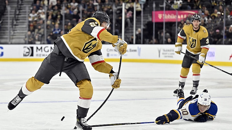 St. Louis Blues center Brayden Schenn (10) breaks up a shot by Vegas Golden Knights defenseman Shea Theodore, left, during the second period of an NHL hockey game Monday, Jan. 20, 2025, in Las Vegas. (AP Photo/David Becker)