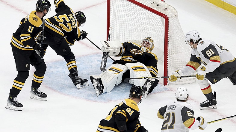 Vegas Golden Knights right wing Mark Stone (61) scores as Boston Bruins goaltender Jeremy Swayman (1) falls on top of the puck inside the net during the second period of an NHL hockey game, Saturday, Feb. 8, 2025, in Boston. (AP Photo/Mark Stockwell)