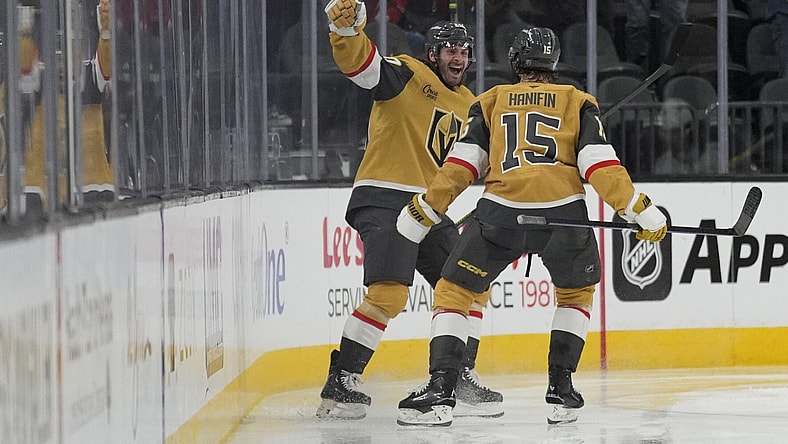 Vegas Golden Knights left wing Brandon Saad, left, celebrates after scoring against the Vancouver Canucks during the third period of an NHL hockey game Saturday, Feb. 22, 2025, in Las Vegas. (AP Photo/John Locher)