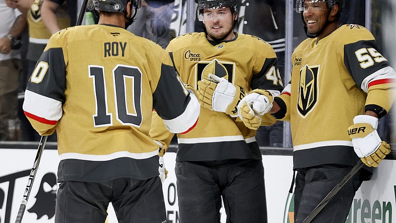 Vegas Golden Knights centers Nicolas Roy (10) and Ivan Barbashev (49) celebrate with right wing Keegan Kolesar (55) after Kolesar's goal during the second period of an NHL hockey game against the Chicago Blackhawks Thursday, Feb. 27, 2025, in Las Vegas. (AP Photo/Ian Maule)
