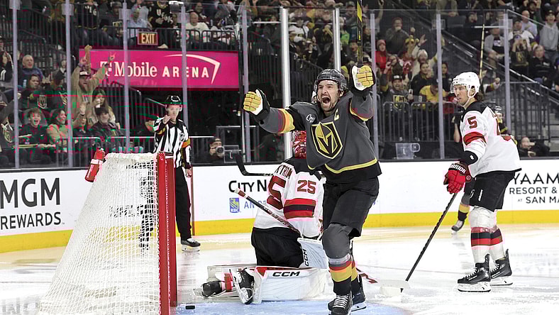 Vegas Golden Knights right wing Mark Stone, center, celebrates after scoring against New Jersey Devils goaltender Jacob Markstrom (25) during the third period of an NHL hockey game, Sunday, March 2, 2025, in Las Vegas. New Jersey Devils defenseman Brenden Dillon (5) looks on at right. (Steve Marcus/Las Vegas Sun via AP)