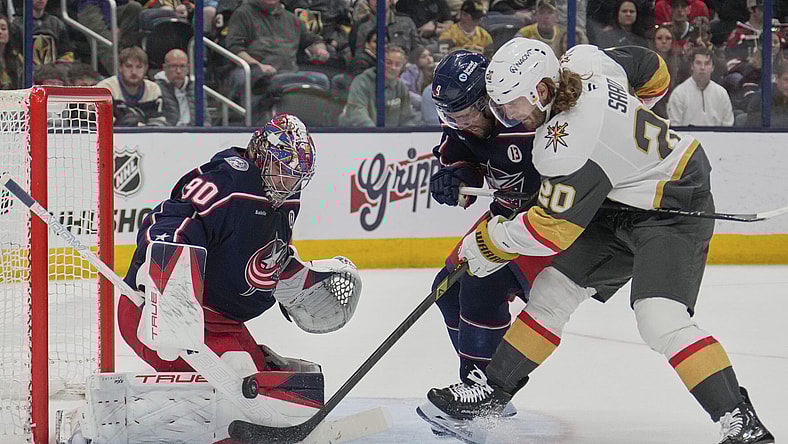 Vegas Golden Knights left wing Brandon Saad (20) shoots on Columbus Blue Jackets goaltender Elvis Merzlikins (90) next to defenseman Ivan Provorov (9) in the first period of an NHL hockey game Thursday, March 13, 2025, in Columbus, Ohio. (AP Photo/Sue Ogrocki)