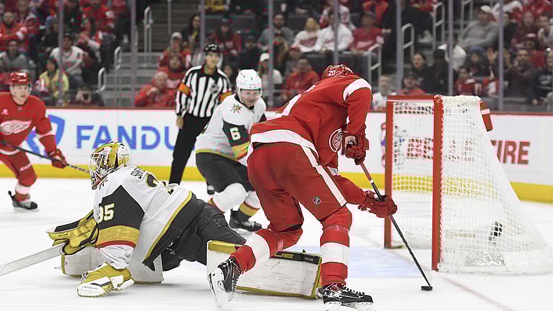Detroit Red Wings defenseman Albert Johansson, right, skates past Vegas Golden Knights goaltender Ilya Samsonov (35) and scores a goal during the second period of an NHL hockey game, Sunday, March 16, 2025, in Detroit. (AP Photo/Jose Juarez)