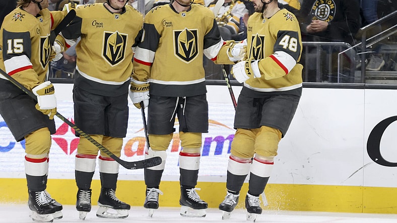 Vegas Golden Knights defenseman Noah Hanifin (15), left wing Pavel Dorofeyev (16), center Jack Eichel (9) and center Tomas Hertl (48) celebrate after Dorofeyev's first goal during the second period of an NHL hockey game against the Boston Bruins Thursday, March 20, 2025, in Las Vegas. (AP Photo/Ian Maule)