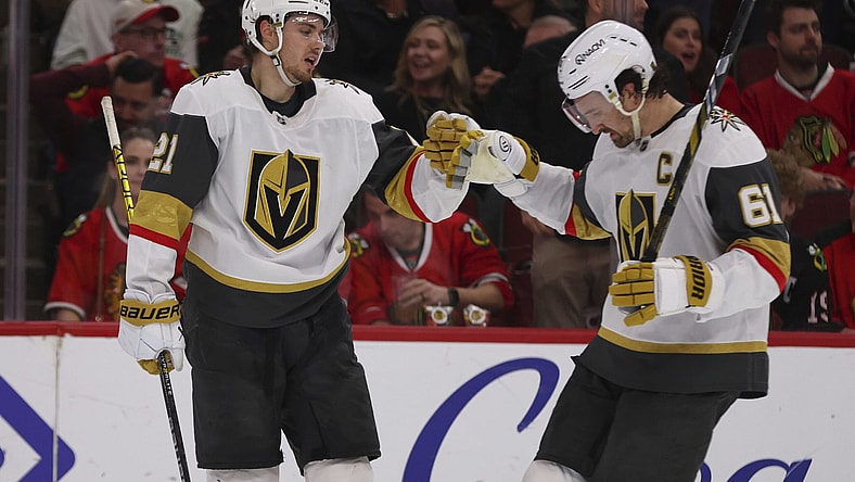 Vegas Golden Knights center Brett Howden (21) celebrates with right wing Mark Stone (61) after scoring an empty-net goal during the third period of an NHL hockey game against the Chicago Blackhawks, Friday, March 28, 2025, in Chicago. (AP Photo/Melissa Tamez)