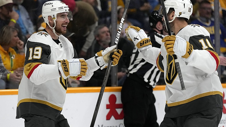 Vegas Golden Knights right wing Reilly Smith (19) celebrates with Nicolas Roy (10) after Smith scored a goal against the Nashville Predators during the third period of an NHL hockey game Saturday, March 29, 2025, in Nashville, Tenn. (AP Photo/Mark Humphrey)