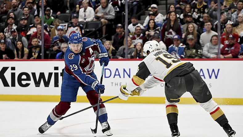 Colorado Avalanche center Nathan MacKinnon (29) skates against Vegas Golden Knights defenseman Noah Hanifin (15) in the first period of an NHL hockey game Tuesday, April 8, 2025, in Denver. (AP Photo/Geneva Heffernan)