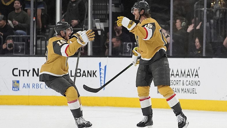 Vegas Golden Knights right wing Reilly Smith (19) celebrates after Vegas Golden Knights defenseman Noah Hanifin, right, scored against the Nashville Predators during the third period of an NHL hockey game Saturday, April 12, 2025, in Las Vegas. (AP Photo/John Locher)