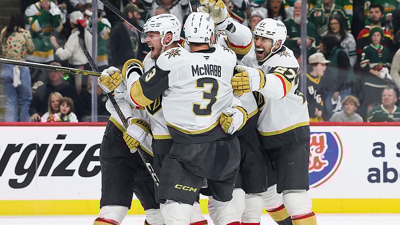 Vegas Golden Knights center Ivan Barbashev (49) celebrates with teammates after scoring a goal the winning goal during overtime in Game 4 of an NHL hockey Stanley Cup first-round playoff series against the Minnesota Wild, Saturday, April 26, 2025, in St. Paul, Minn. (AP Photo/Stacy Bengs)