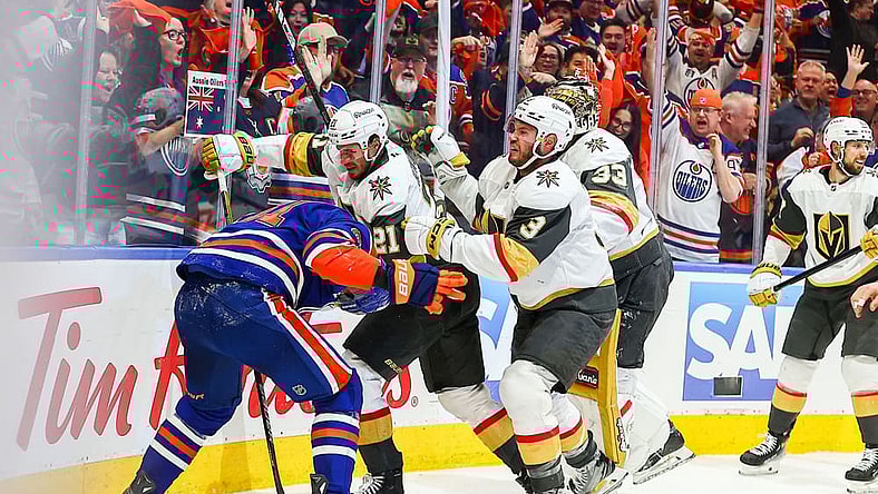 EDMONTON, AB - MAY 12: Las Vegas Golden Knights Center Brett Howden (21) and Las Vegas Golden Knights Goalie Aden Hill (33) attack Edmonton Oilers Right Wing Evander Kane (91) in the first period of the Stanley Cup Playoffs Second Round Edmonton Oilers game versus the Las Vegas Golden Knights on May 12, 2025 at Rogers Place in Edmonton, AB. (Photo by Curtis Comeau/Icon Sportswear)