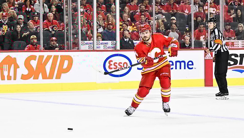 CALGARY, AB - OCTOBER 18: Calgary Flames Defenceman Rasmus Andersson (4) passes the puck during the second period of an NHL game between the Calgary Flames and the Vegas Golden Knights on October 18, 2022, at the Scotiabank Saddledome in Calgary, AB. (Photo by Brett Holmes/Icon Sportswire)
