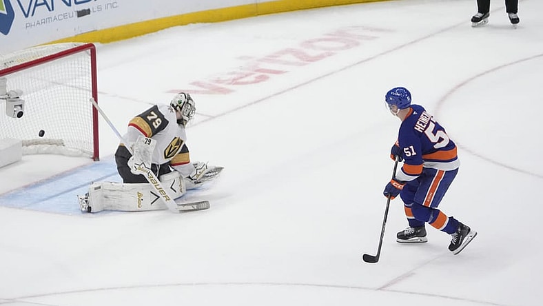 ELMONT, NY - DECEMBER 09: New York Islanders Left Wing Emil Heineman (51) scores the winning goal against Vegas Golden Knights Goalie Carter Hart (79) during the shootout of the National Hockey League game between the Vegas Golden Knights and the New York Islanders on December 9, 2025, at UBS Arena in Elmont, NY. (Photo by Gregory Fisher/Icon Sportswire)