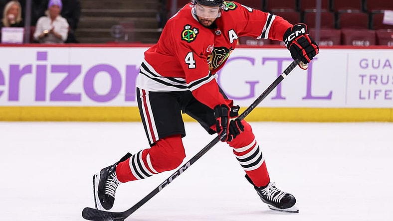 CHICAGO, IL - JANUARY 26: Seth Jones #4 of the Chicago Blackhawks controls the puck during the third period against the Minnesota Wild on January 26, 2025 at the United Center in Chicago, Illinois. (Photo by Melissa Tamez/Icon Sportswire)