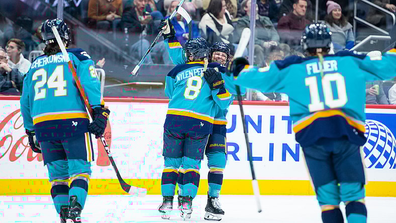 New York Sirens forwards Sarah Fillier, Paetyn Levis, and Anne Cherkowski celebrate with Maja Nylen Persson during a 2-1 win over the Montreal Victoire.