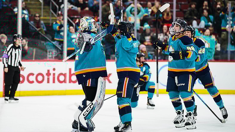 New York Sirens goalie Kayle Osborne celebrates a 4-3 win over the Montreal Victoire with teammates.