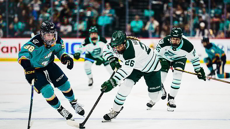 Boston Fleet forward Ella Huber breaks ahead with the puck as Sirens rookie Kristyna Kaltounkova defends.