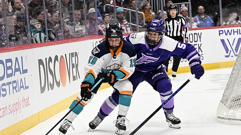 New York Sirens forward Paetyn Levis wards off Minnesota Frost defender Sidney Morin.
