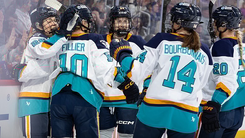 New York Sirens first-liners Casey O'Brien, Sarah Fillier, and Anne Cherkowski celebrate after all factoring into a goal against the Montreal Victoire.