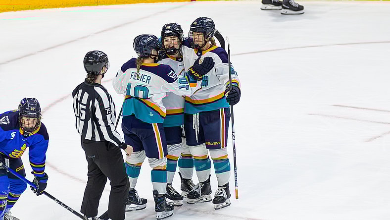 New York Sirens forwards Sarah Fillier and Casey O'Brien celebrate with defender Allyson Simpson, who scored the 1-0 overtime winner against the Toronto Sceptres.