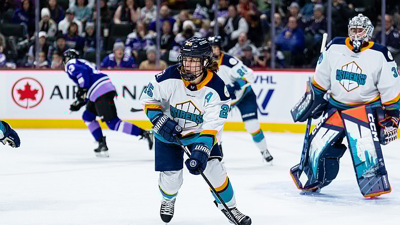 New York Sirens alternate captain Alex Carpenter skates in front of goalie Corinne Schroeder.
