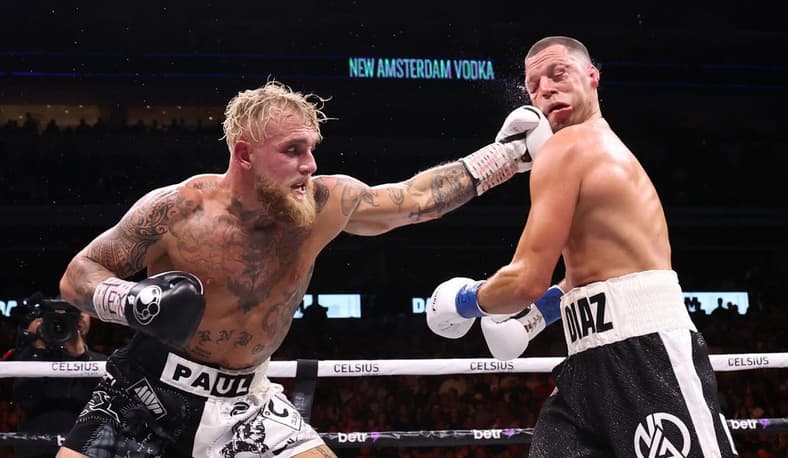 Aug 5, 2023; Dallas, Texas, USA; Jake Paul (left) fights against Nate Diaz in a boxing match at American Airlines Center. Mandatory Credit: Kevin Jairaj-USA TODAY Sports