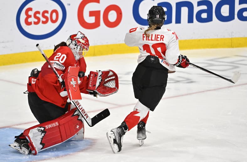 Hockey: IIHF Women's World Championship Hockey. Swiss goalie Andrea Brändli makes a save on New York Sirens forward Sarah Fillier.