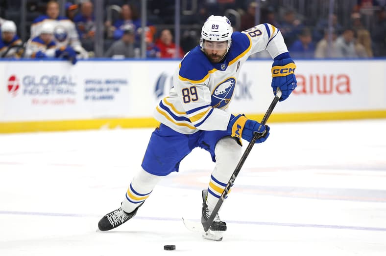Buffalo Sabres right wing Alex Tuch (89) skates with the puck during the third period of an NHL hockey game against the New York Islanders, Saturday, Nov. 30, 2024, in Elmont, N.Y. (AP Photo/Noah K. Murray), Detroit Red Wings Target