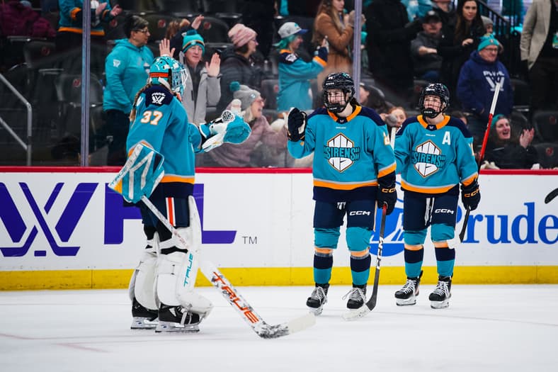 New York Sirens rookie Anne Cherkowski fist bumbs Callie Shanahan after scoring a goal against the Ottawa Charge.