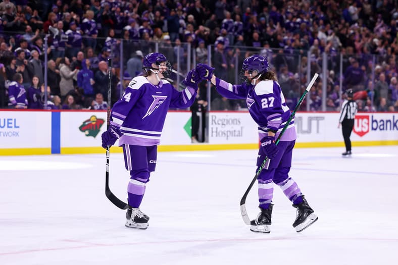 Minnesota Frost forwards Taylor Heise and Abby Hustler celebrate after a goal.