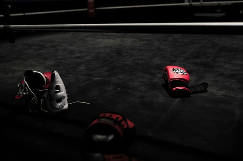 red boxing gloves and helmet on floor