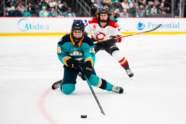 New York Sirens defender Lauren Bernard passes from the puck from her knees against the Ottawa Charge.