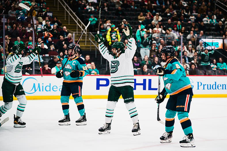 The Boston Fleet celebrate after scoring a goal against the New York Sirens.