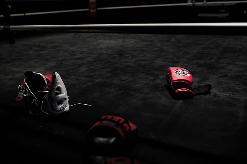 red boxing gloves and helmet on floor