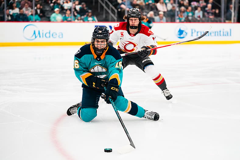 New York Sirens defender Lauren Bernard passes from the puck from her knees against the Ottawa Charge.