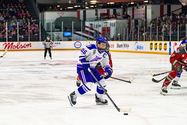 Minnesota Frost forward Kendall Coyne Schofield drives the net against the Ottawa Charge.