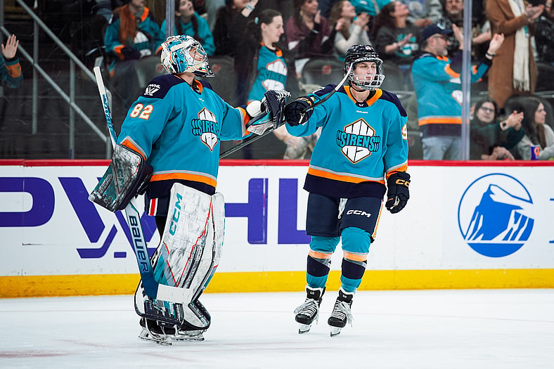 New York Sirens forward Kristyna Kaltounkova fist bumps goalie Kayle Osborne
