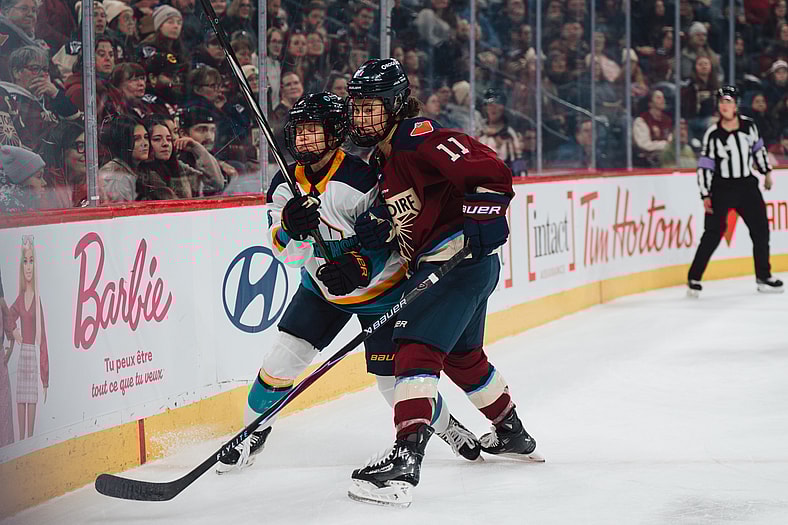Montreal Victoire forward Abby Roque dishes out a hit on New York Sirens defender Maja Nylen Persson.