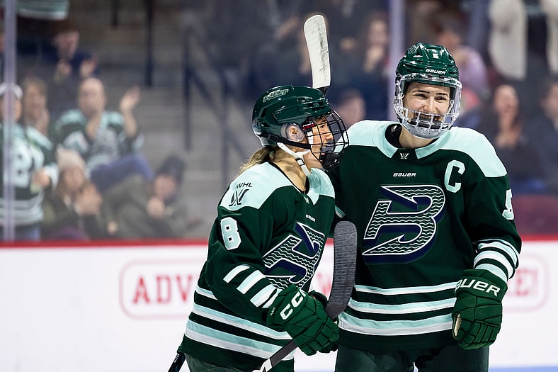 Boston Fleet defenders Megan Keller and Haley Winn celebrate together.