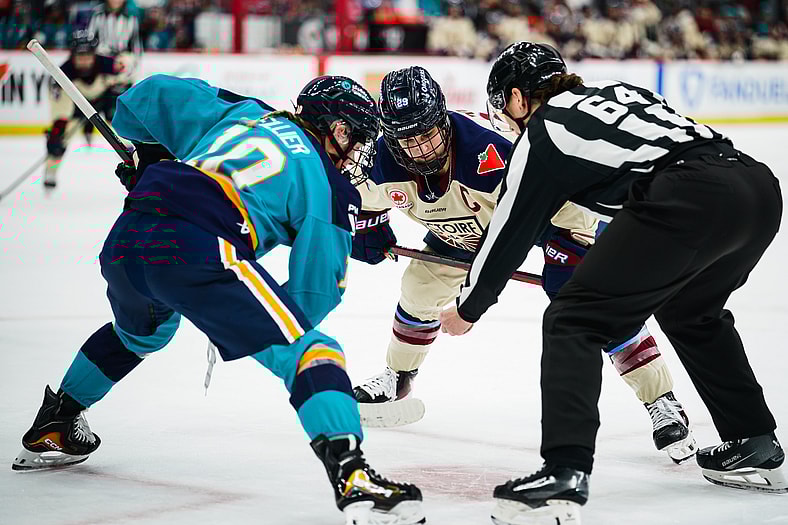 New York Sirens forward Sarah Fillier takes a faceoff against Montreal Victoire center Marie-Philip Poulin.