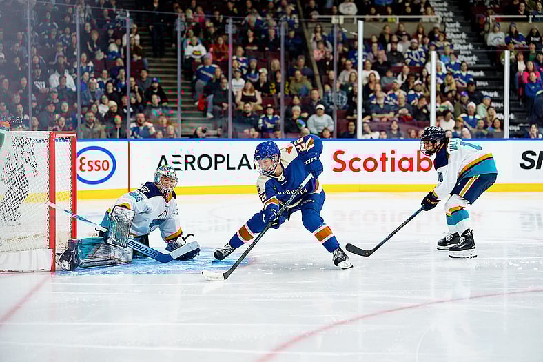 Vancouver Goldeneyes forward Abby Boreen goes to her backhand against New York Sirens goalie Kayle Osborne on a breakaway.