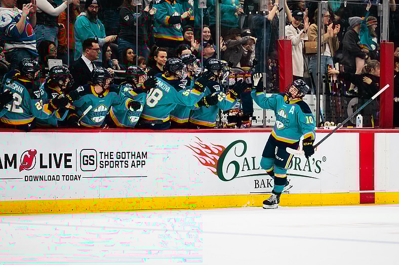 New York Sirens forward Sarah Fillier high-fives teammates after a goal.