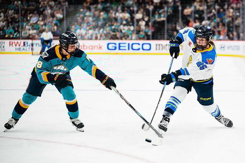 New York Sirens defender Maja Nylen Persson extends her stick for a poke check against Toronto Sceptres forward Clara Van Wieren.