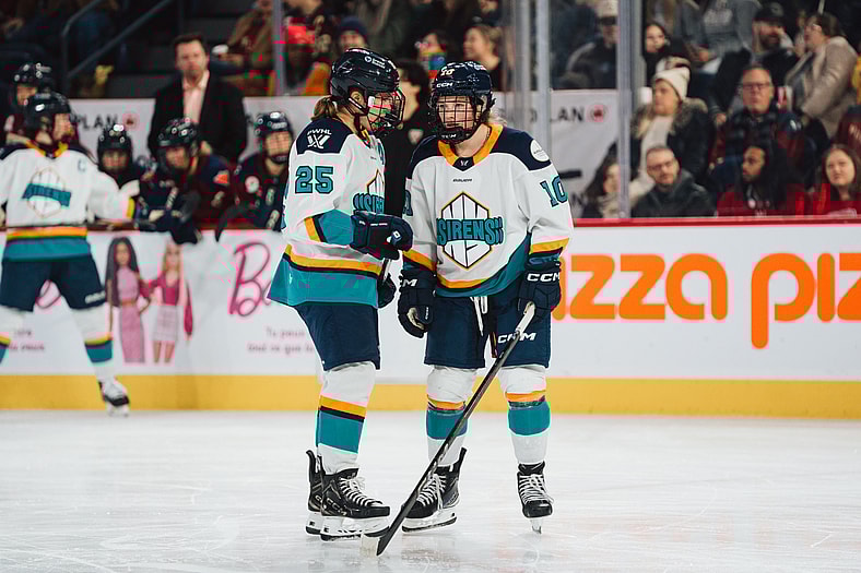 New York Sirens forwards Alex Carpenter and Sarah Fillier talk during a game against the Montreal Victoire.
